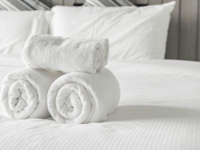 White towel on bed decoration in bedroom interior - Vintage light Filter